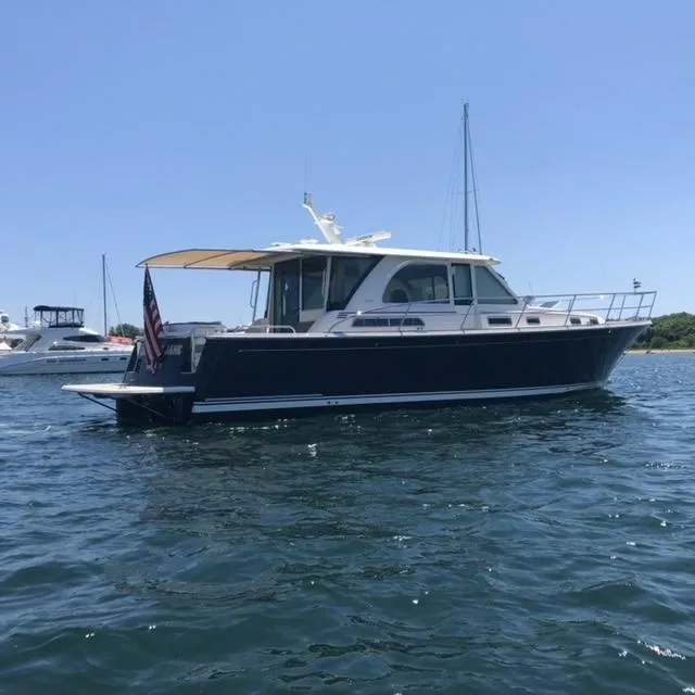 Slide: The Image of 2018 Sabre 45 Salon Express yacht on calm water, side view. - 3