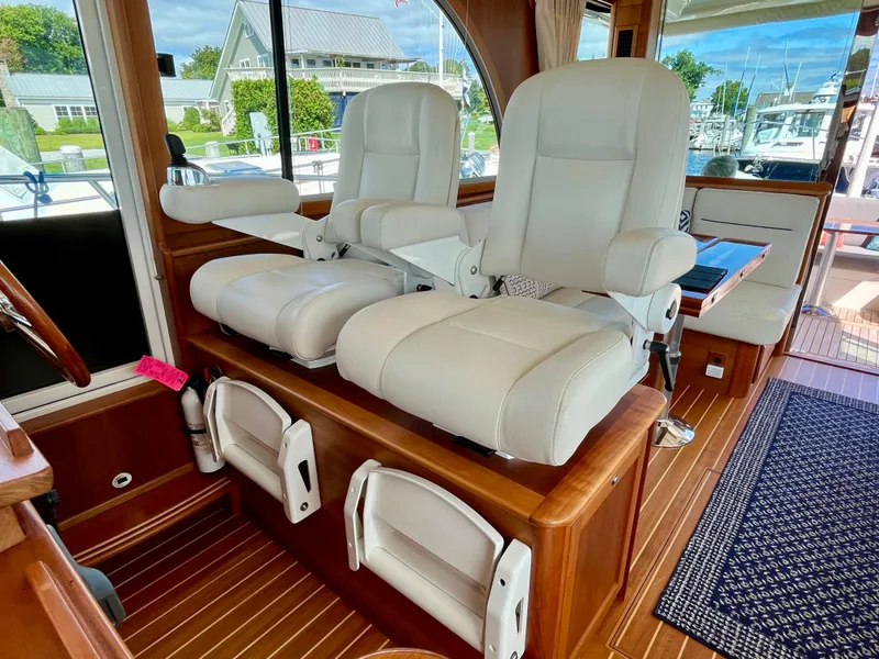 Slide: The Image of Interior of 2018 Sabre 45 Salon Express with plush white captain chairs. - 33