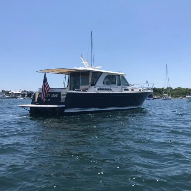 Slide: The Image of 2018 Sabre 45 Salon Express yacht on calm water, sunny day. - 4