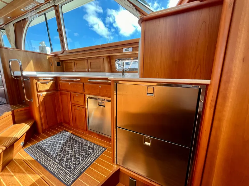 Slide: The Image of Interior of 2018 Sabre 45 Salon Express yacht with wooden cabinetry and stainless steel appliances. - 40