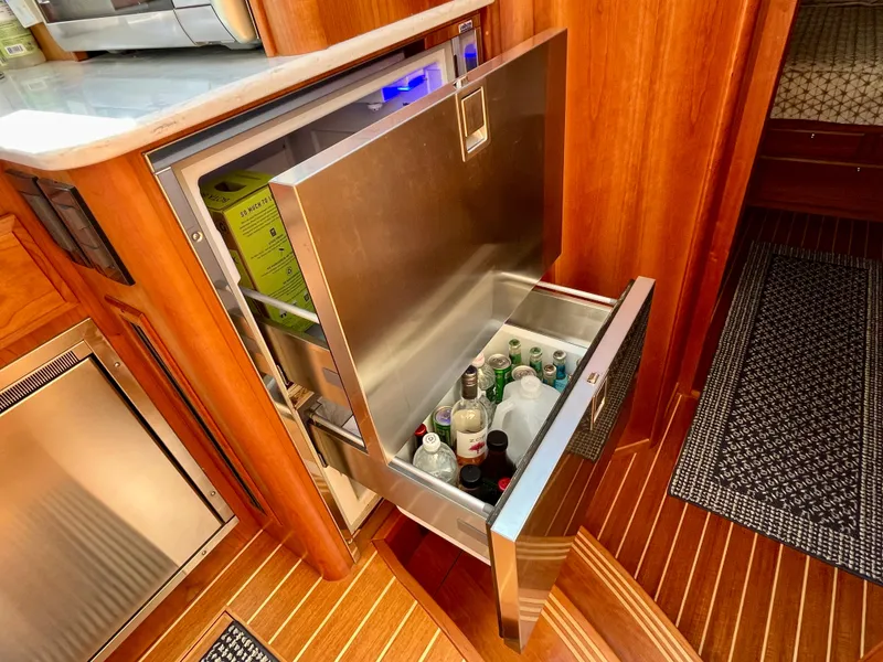 Slide: The Image of Open drawer fridge in 2018 Sabre 45 Salon Express yacht interior, stocked with beverages. - 42