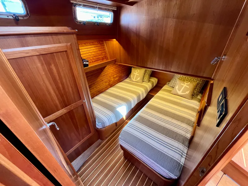 Slide: The Image of 2018 Sabre 45 Salon Express cabin with twin beds, wooden interior, and nautical decor. - 44