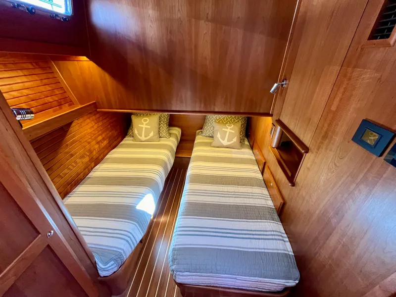 Slide: The Image of Twin cabin with striped bedding in 2018 Sabre 45 Salon Express yacht. - 45