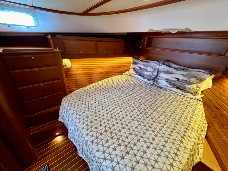 Slide: The Image of Luxurious bedroom interior of 2018 Sabre 45 Salon Express yacht with wood paneling. - 49
