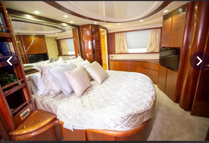 Slide: The Image of Luxurious bedroom interior of 2003 Azimut 74 Solar yacht with elegant wood finishes. - 14