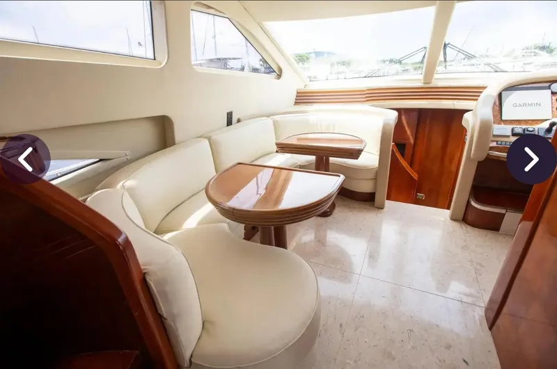Slide: The Image of Luxurious interior of 2003 Azimut 74 Solar yacht with cream seating and wooden accents. - 7