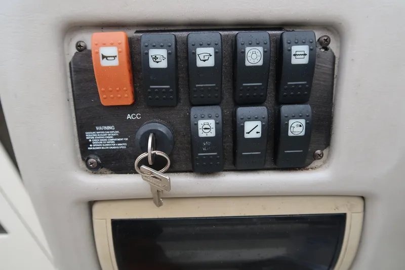 Slide: The Image of Control panel with switches and key for 2004 Stingray 240 CS boat. - 16