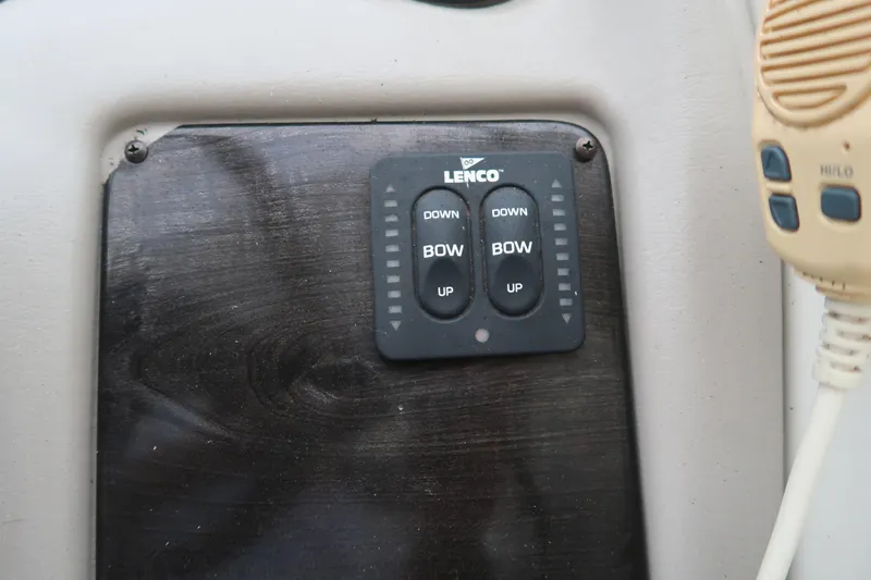 Slide: The Image of Control panel of a 2004 Stingray 240 CS boat with Lenco trim tab switches. - 17
