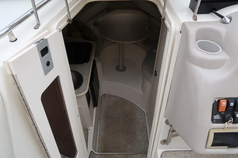 Slide: The Image of 2004 Stingray 240 CS cabin interior with compact design and amenities. - 22