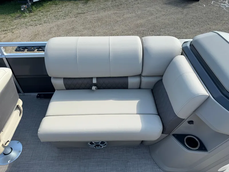 Slide: The Image of 2025 Sun Tracker Fishin' Barge 20 DLX boat seating with beige upholstery and cup holder. - 10