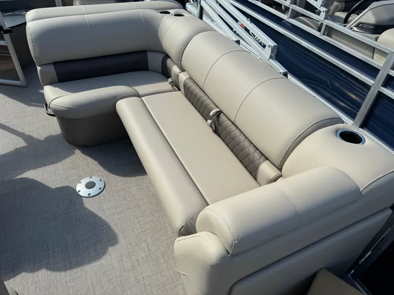 Slide: The Image of 2025 Sun Tracker Fishin' Barge 20 DLX, beige seating, cup holders, and spacious deck. - 11