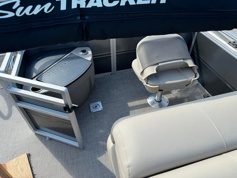 Slide: The Image of 2025 Sun Tracker Fishin' Barge 20 DLX interior with seating and storage. - 14
