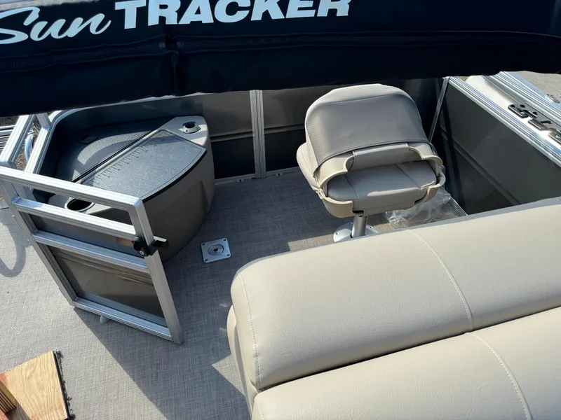 Slide: The Image of 2025 Sun Tracker Fishin' Barge 20 DLX interior with seating and storage. - 15