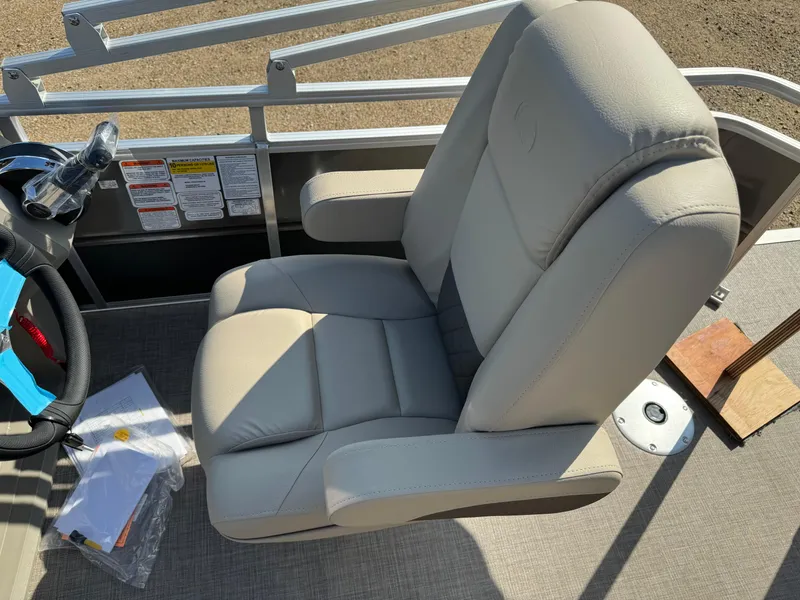 Slide: The Image of 2025 Sun Tracker Fishin' Barge 20 DLX captain's chair, beige upholstery, on deck. - 21