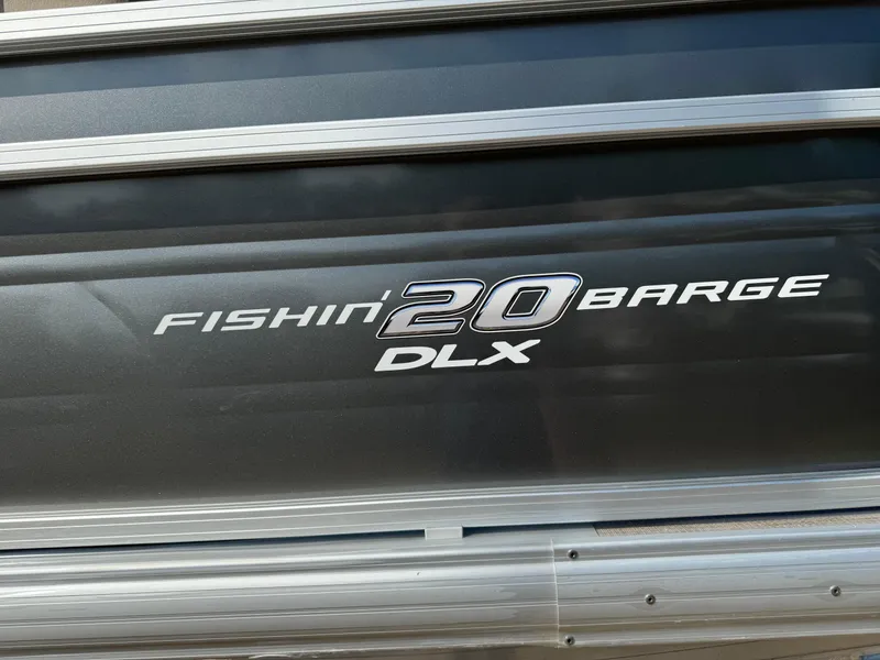 Slide: The Image of 2025 Sun Tracker Fishin' Barge 20 DLX logo on boat exterior. - 3