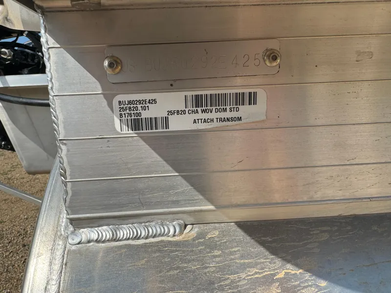 Slide: The Image of 2025 Sun Tracker Fishin' Barge 20 DLX transom with serial and model labels. - 6