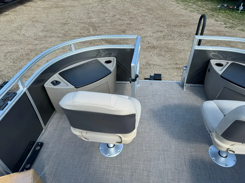 Slide: The Image of 2025 Sun Tracker Fishin' Barge 20 DLX interior with swivel seats and storage compartments. - 7