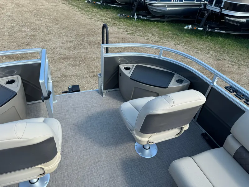 Slide: The Image of 2025 Sun Tracker Fishin' Barge 20 DLX interior with seating and storage compartments. - 8