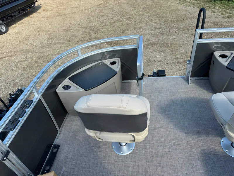 Slide: The Image of 2025 Sun Tracker Fishin' Barge 20 DLX interior with seating and storage compartments. - 9