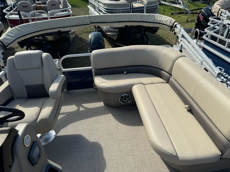 Slide: The Image of 2024 Sun Tracker Bass Buggy 16 XL Select pontoon boat with beige seating and steering console. - 10
