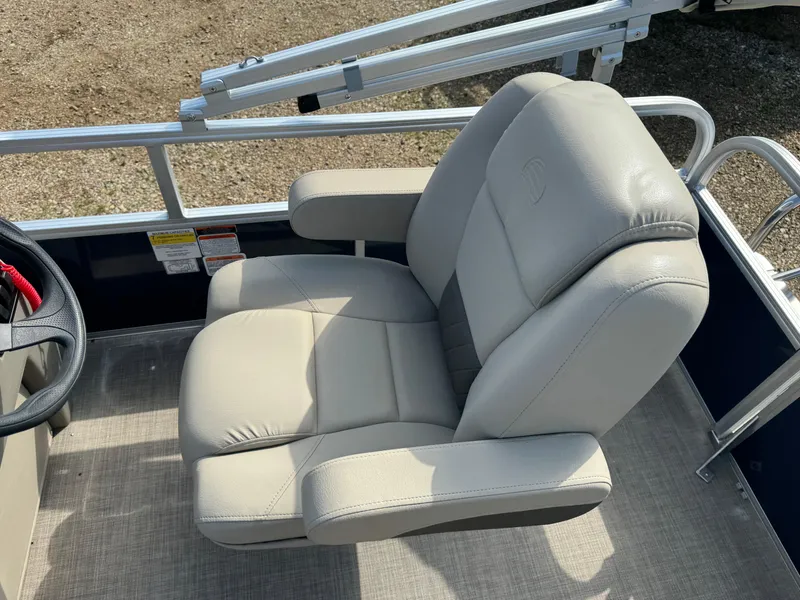 Slide: The Image of 2024 Sun Tracker Bass Buggy 16 XL Select boat seat, beige upholstery, steering wheel visible. - 11