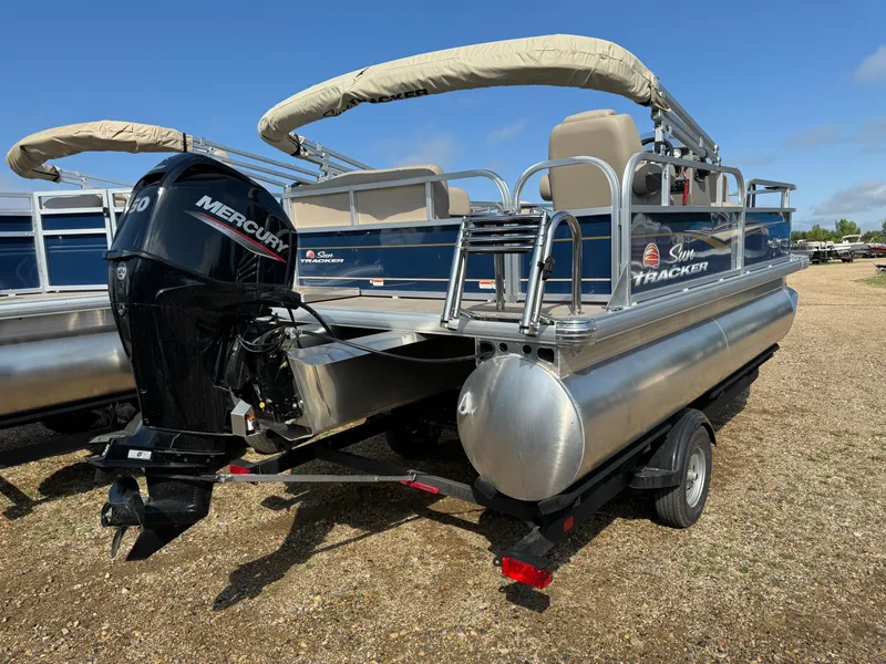 Slide: The Image of 2024 Sun Tracker Bass Buggy 16 XL Select pontoon boat with Mercury engine on trailer. - 3