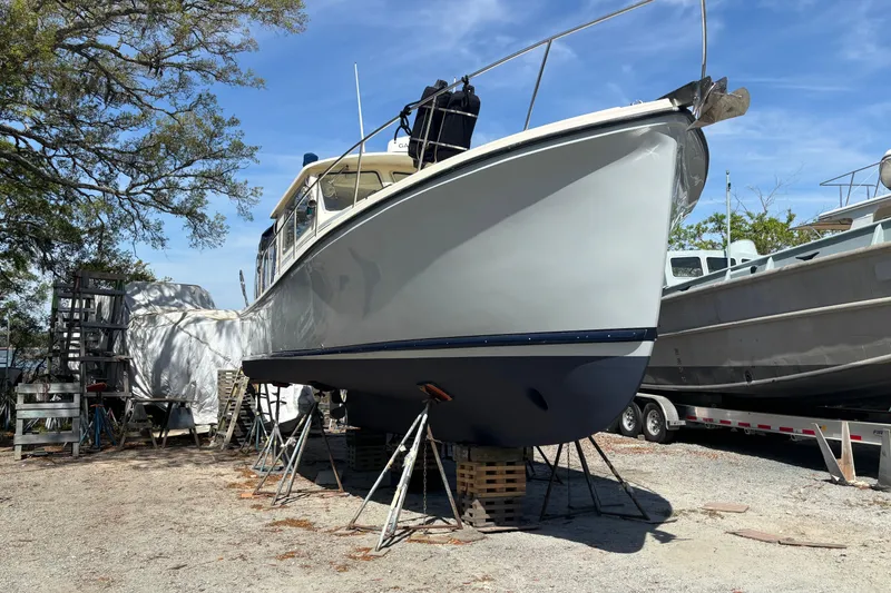 Slide: The Image of 2004 Atlas Boat Works Acadia 32 on stands outdoors. - 17