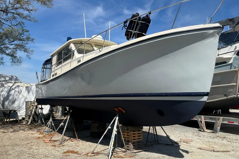 Slide: The Image of 2004 Atlas Boat Works Acadia 32 yacht on stands outdoors. - 21