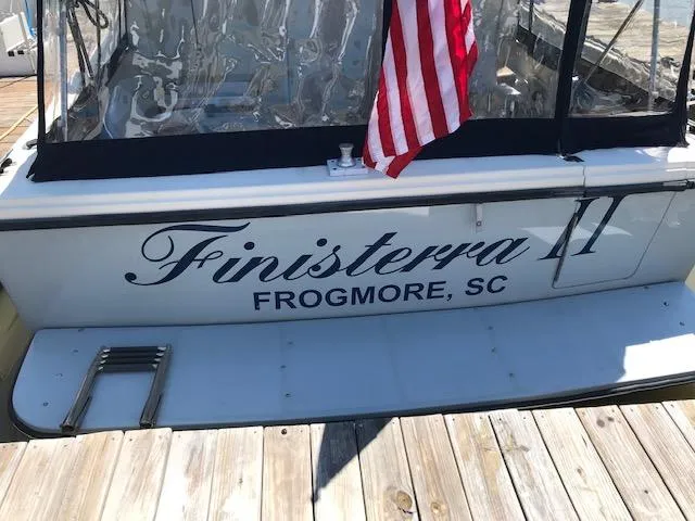 Slide: The Image of Stern view of 2004 Acadia 32 yacht with American flag. - 6