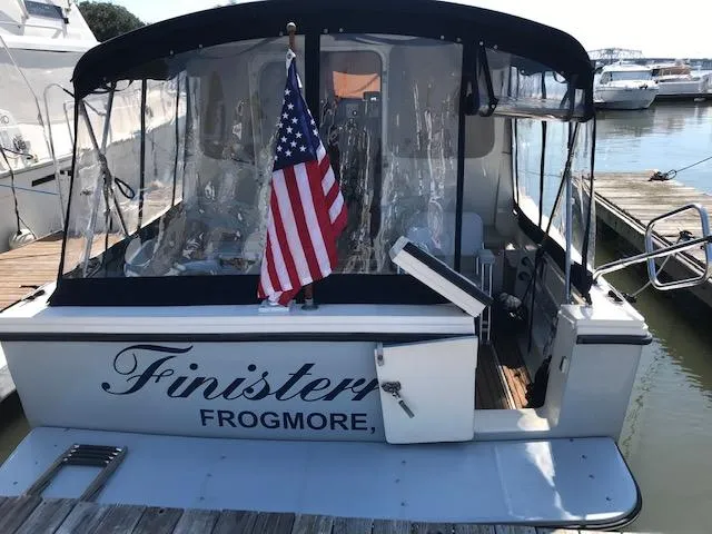 Slide: The Image of Atlas Boat Works Acadia 32, 2004 model, with American flag at dock. - 1