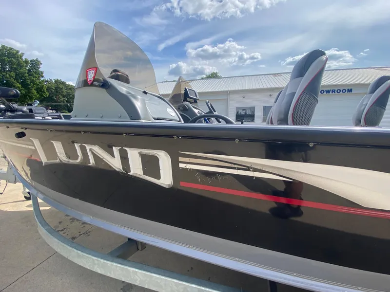 Slide: The Image of 2007 Lund 1900 Pro V SE boat, dual console, black exterior, parked outdoors. - 13
