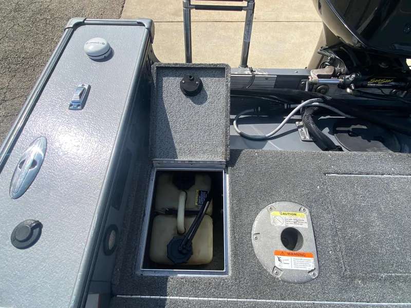 Slide: The Image of 2007 Lund 1900 Pro V SE boat interior with open storage compartment and engine view. - 38