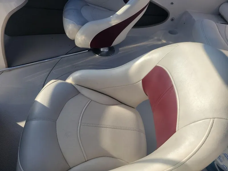 Slide: The Image of 2011 Tahoe Q5i boat seats with white and maroon upholstery. - 3