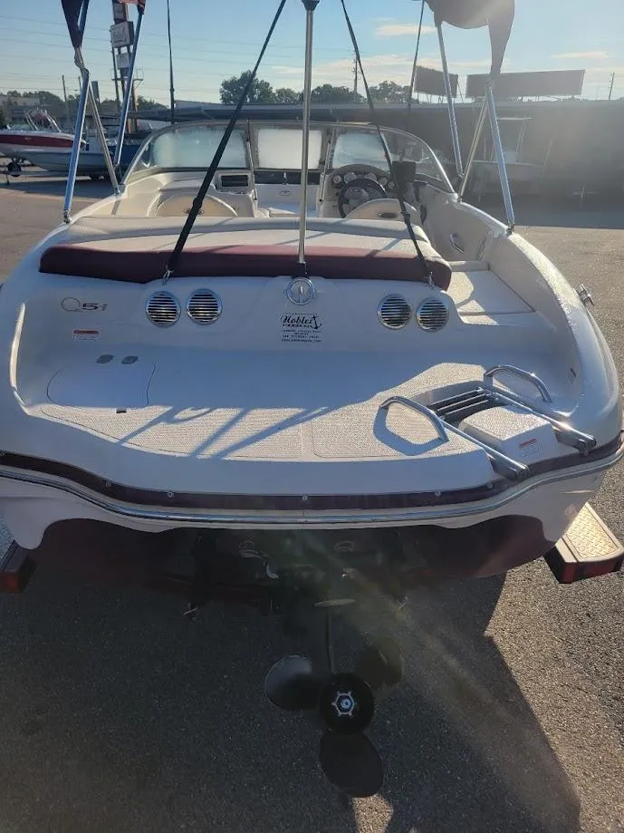 Slide: The Image of 2011 Tahoe Q5i boat, rear view, showcasing deck and propeller in sunlight. - 4