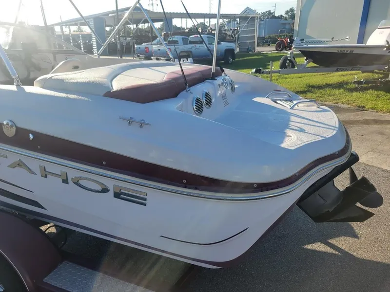 Slide: The Image of 2011 Tahoe Q5i boat on trailer in sunny outdoor setting. - 7