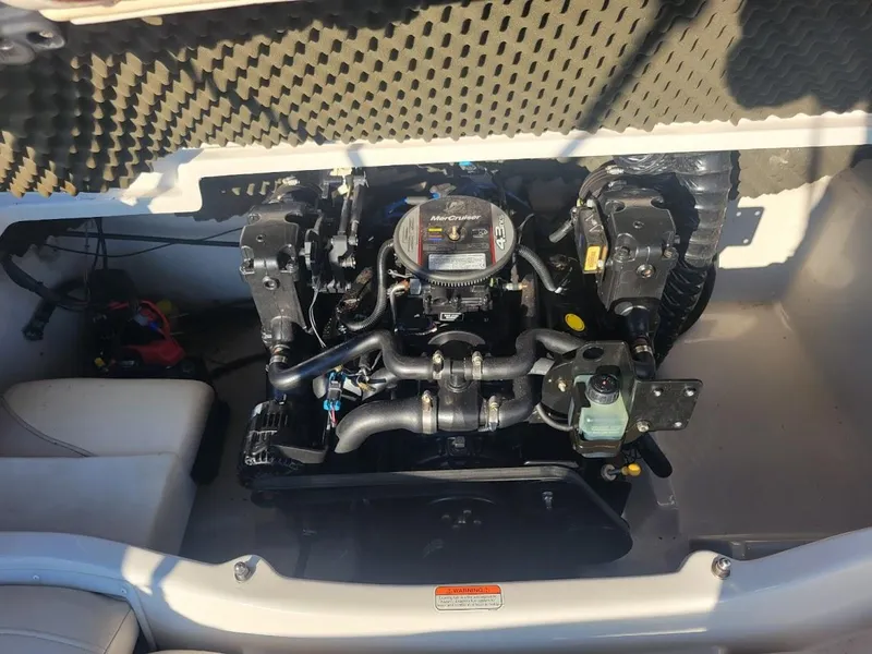 Slide: The Image of 2011 Tahoe Q5i boat engine compartment with visible components and wiring. - 8