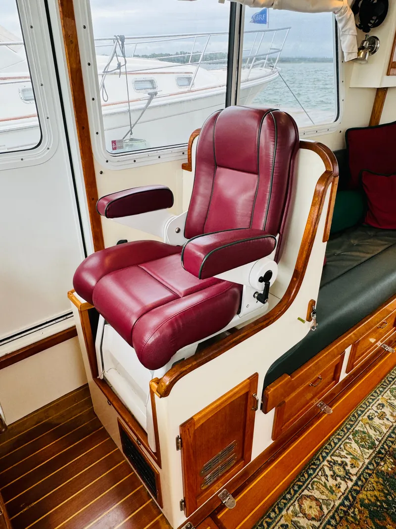 Slide: The Image of Luxurious maroon captain's chair in 2000 Holland 38 Downeast Cruiser interior. - 13