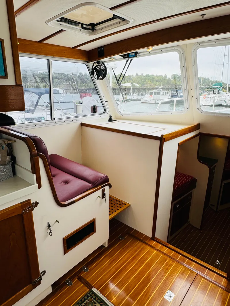 Slide: The Image of Interior of 2000 Holland 38 Downeast Cruiser with wood accents and marina view. - 16