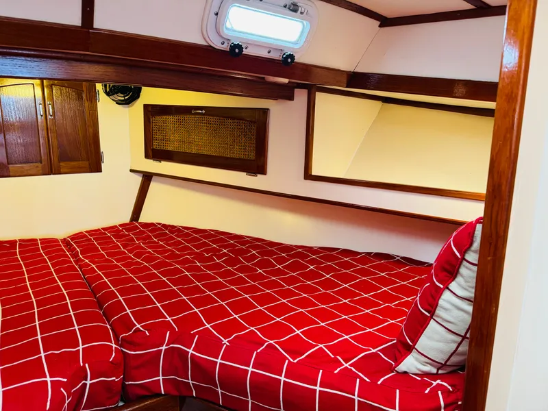 Slide: The Image of Cozy cabin interior of 2000 Holland 38 Downeast Cruiser with red checkered bedding. - 19