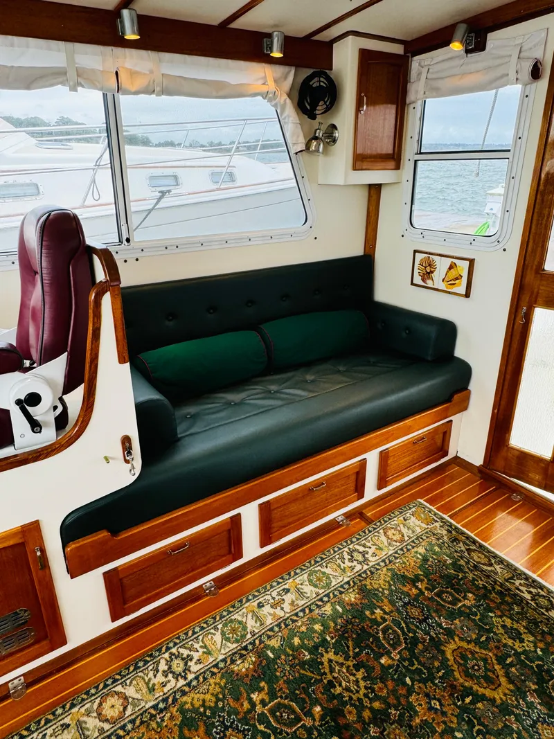 Slide: The Image of Interior of 2000 Holland 38 Downeast Cruiser with sofa and nautical decor. - 2