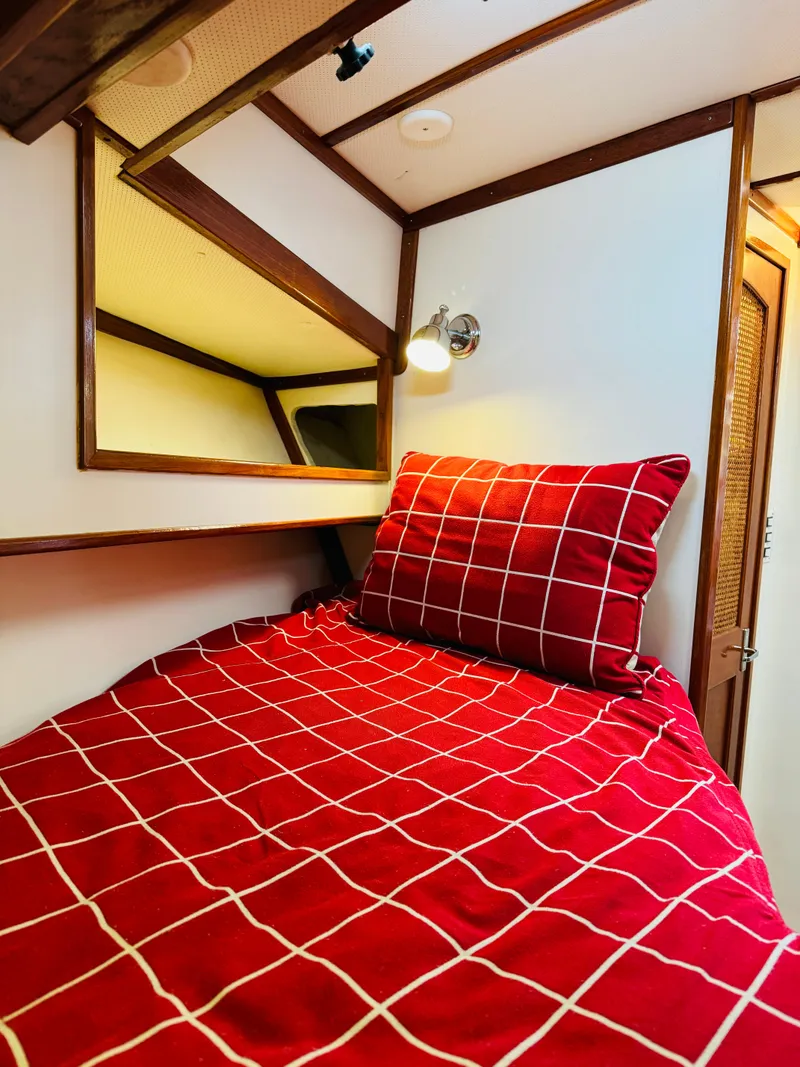 Slide: The Image of Cozy cabin bed with red checkered bedding in 2000 Holland 38 Downeast Cruiser. - 23