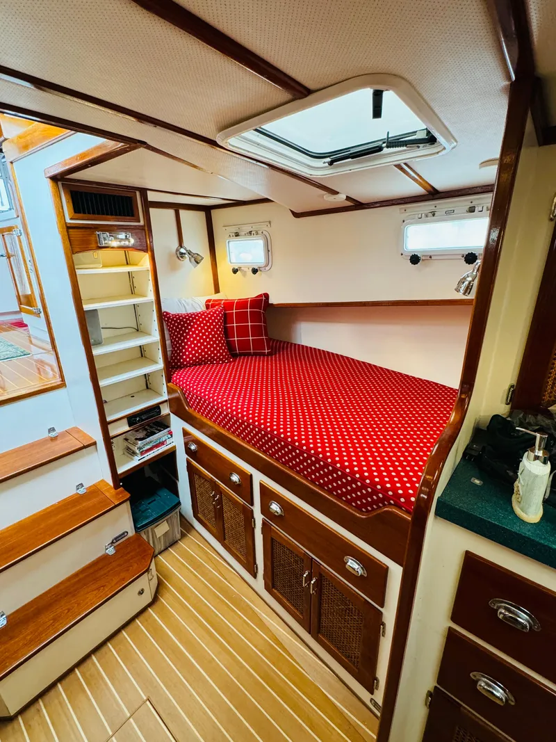 Slide: The Image of Cozy cabin interior of 2000 Holland 38 Downeast Cruiser with red polka dot bedding. - 24