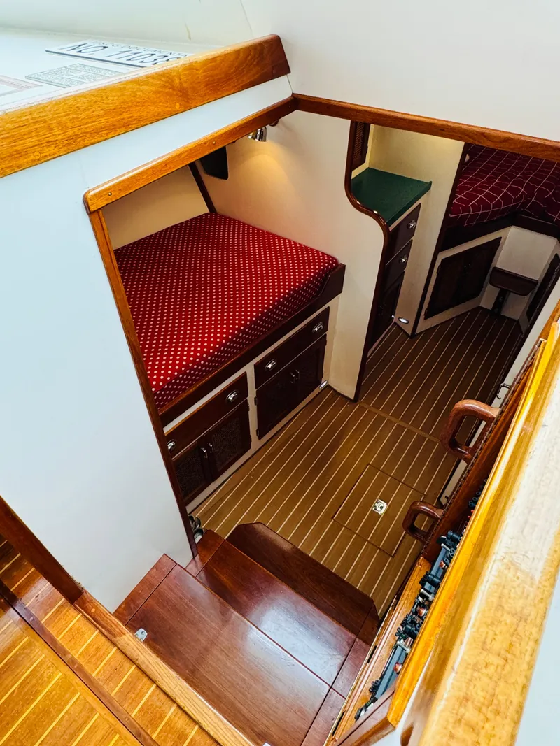 Slide: The Image of Interior of 2000 Holland 38 Downeast Cruiser with wood finish and red upholstery. - 25