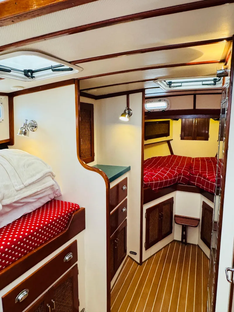 Slide: The Image of Interior of 2000 Holland 38 Downeast Cruiser with cozy cabin and red bedding. - 26