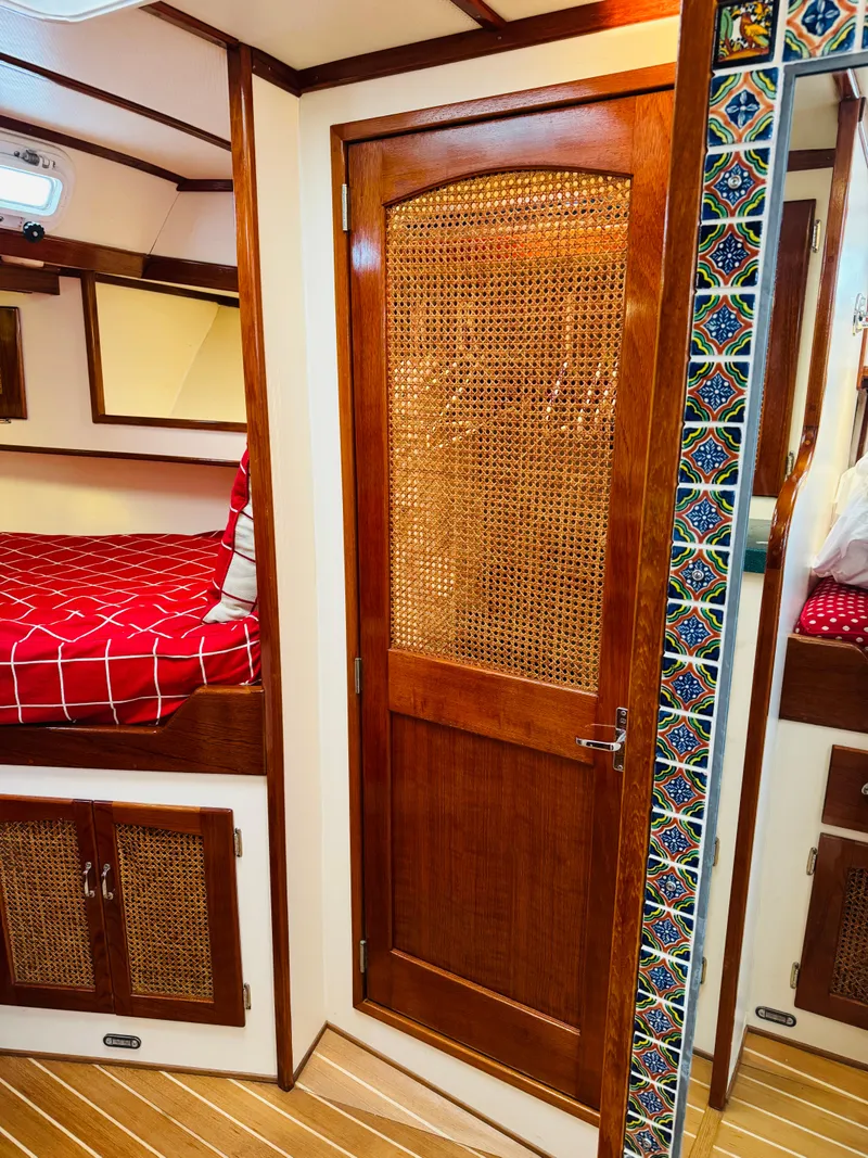 Slide: The Image of Interior of 2000 Holland 38 Downeast Cruiser with wood accents and colorful tile details. - 28