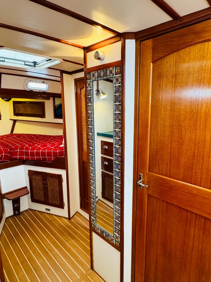 Slide: The Image of Interior of 2000 Holland 38 Downeast Cruiser with wood paneling and cozy cabin. - 29