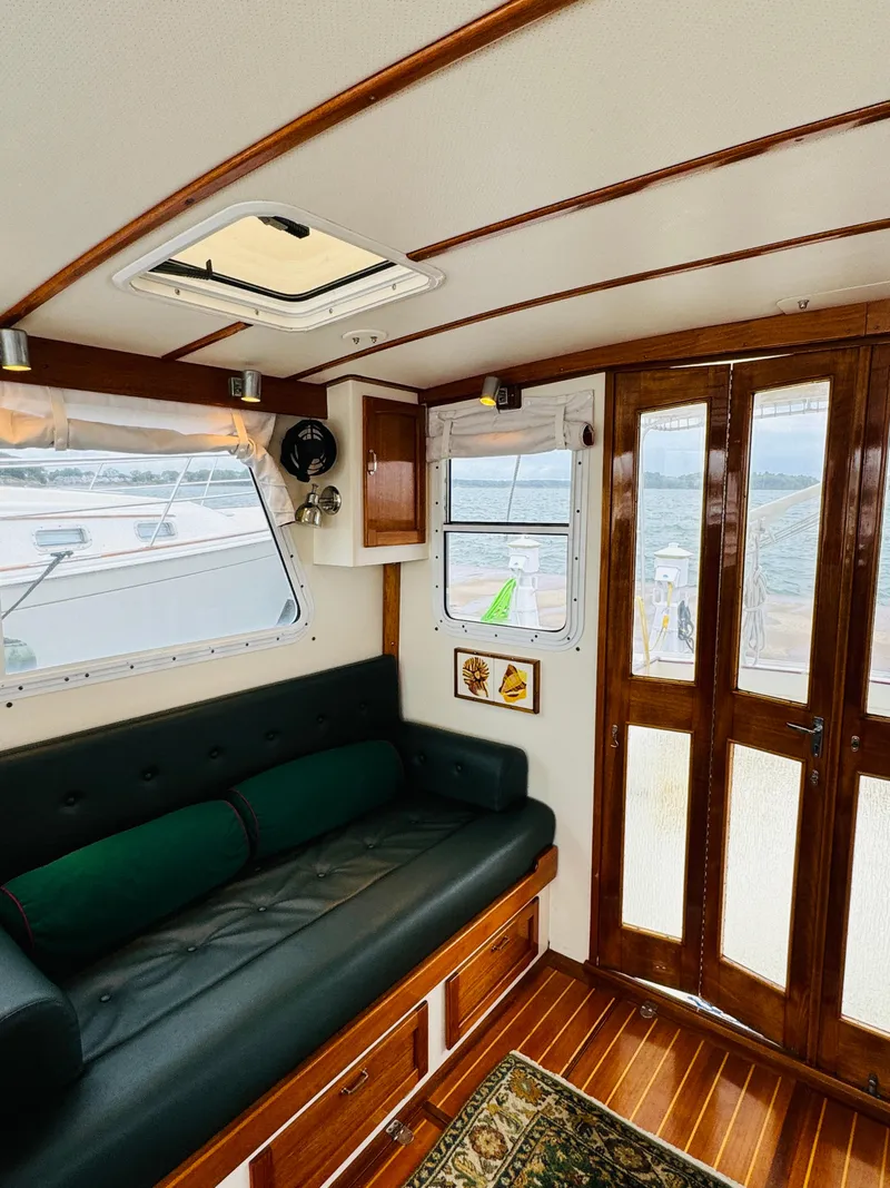 Slide: The Image of Interior of 2000 Holland 38 Downeast Cruiser with wooden accents and seating. - 3