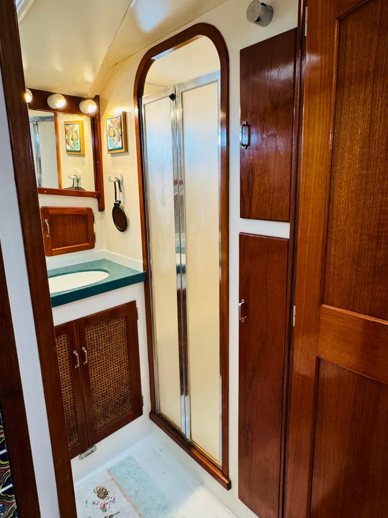 Slide: The Image of Luxurious bathroom in 2000 Holland 38 Downeast Cruiser with wood accents and modern fixtures. - 34