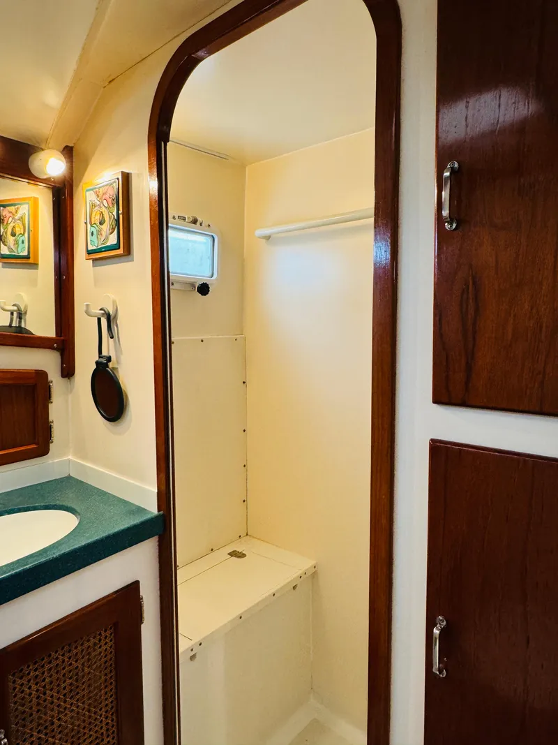 Slide: The Image of Interior of 2000 Holland 38 Downeast Cruiser bathroom with wood accents and sink. - 35