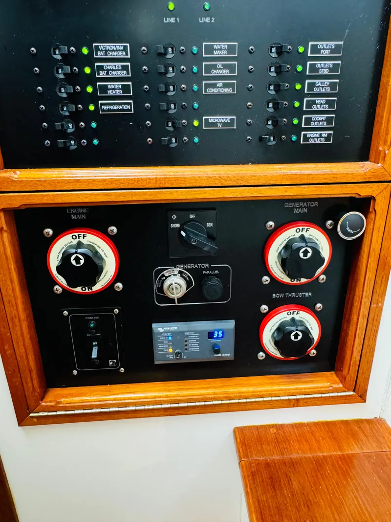 Slide: The Image of Control panel of a 2000 Holland 38 Downeast Cruiser with switches and dials. - 38